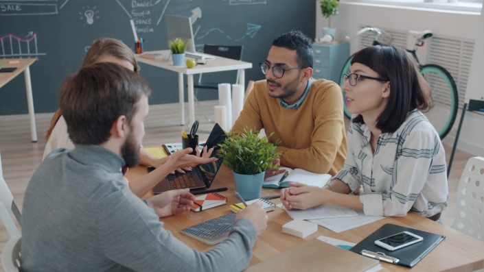 visory-b-people Creative agency team discussing work around a table